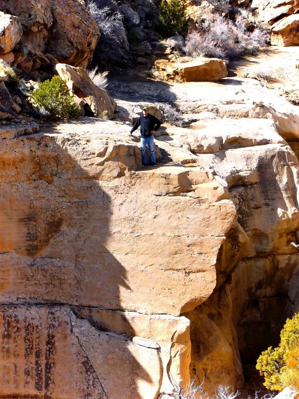 Jered, the fire maker, precariously perched above a desert chasm